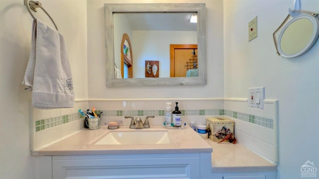 bathroom featuring decorative backsplash and vanity