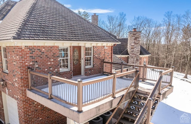 snow covered deck with stairway