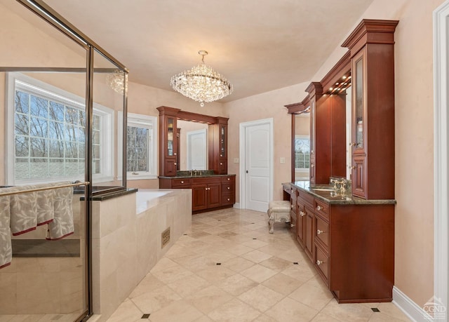 full bathroom featuring a chandelier, two vanities, a stall shower, a bath, and tile patterned floors