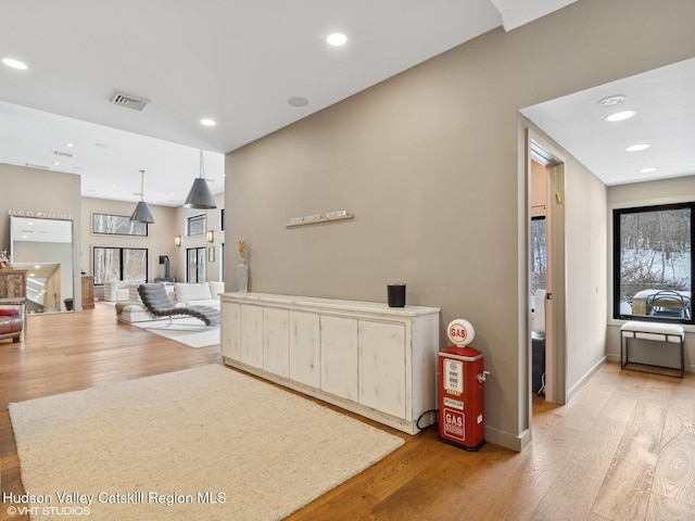 hallway featuring recessed lighting, visible vents, and light wood-style flooring