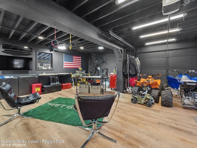 interior space with a garage and wood finished floors