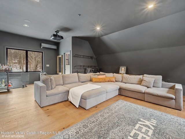 living area featuring lofted ceiling, light wood-style flooring, recessed lighting, and a wall mounted air conditioner