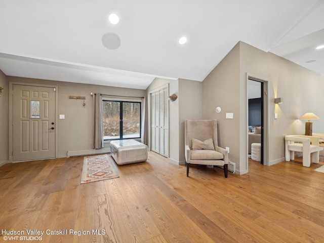 foyer featuring vaulted ceiling, recessed lighting, baseboards, and light wood-style floors