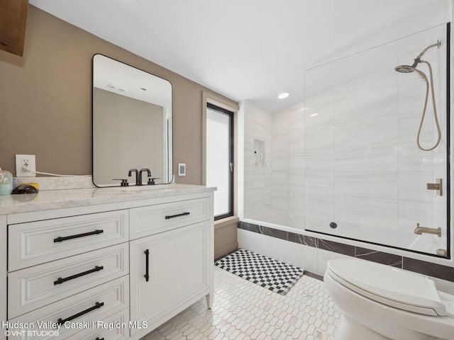 full bath with toilet, tiled shower / bath combo, visible vents, and vanity