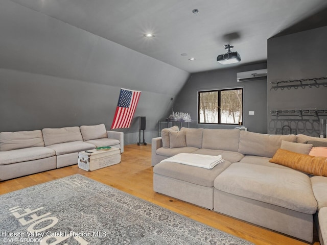 living room featuring lofted ceiling, recessed lighting, wood finished floors, and a wall mounted air conditioner