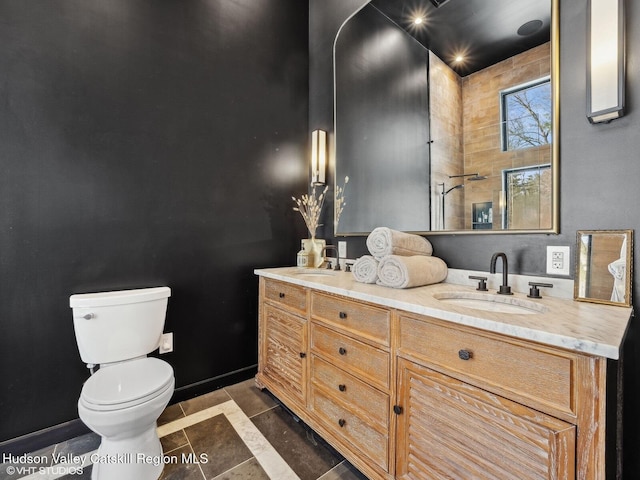 full bathroom with tile patterned floors, a sink, toilet, and double vanity