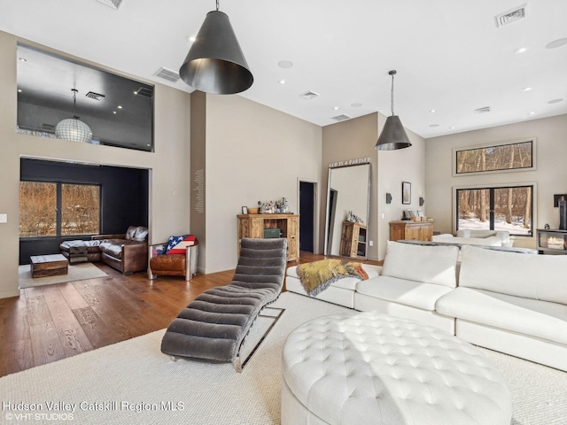 living room featuring wood finished floors, visible vents, and recessed lighting