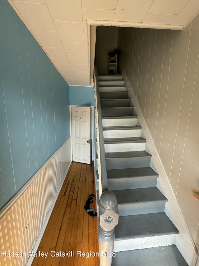 stairway featuring wood-type flooring