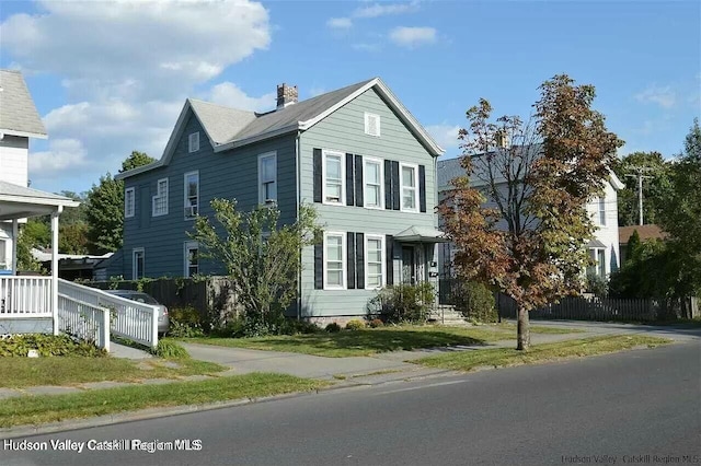 view of front of house featuring fence