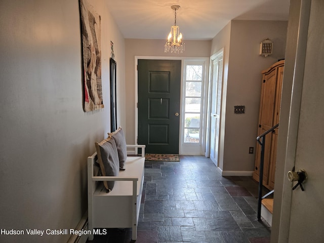 foyer entrance featuring a notable chandelier