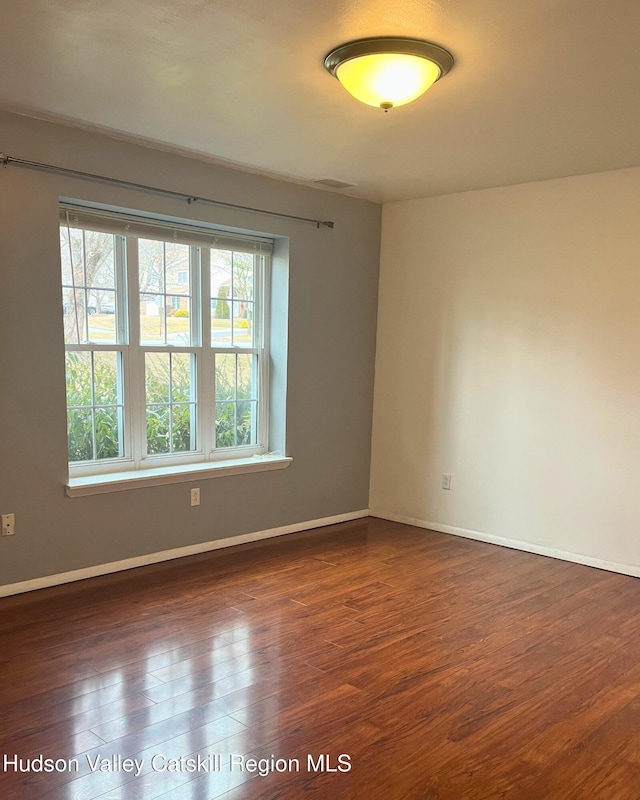 empty room with dark hardwood / wood-style floors