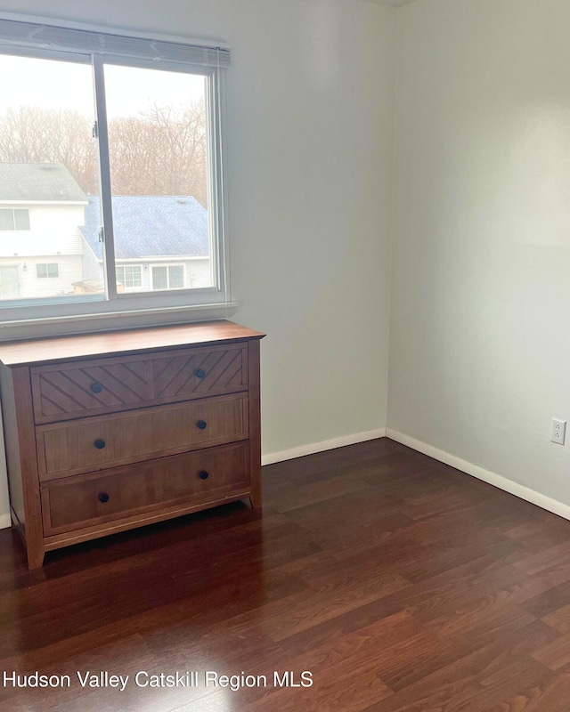 spare room featuring dark wood-type flooring