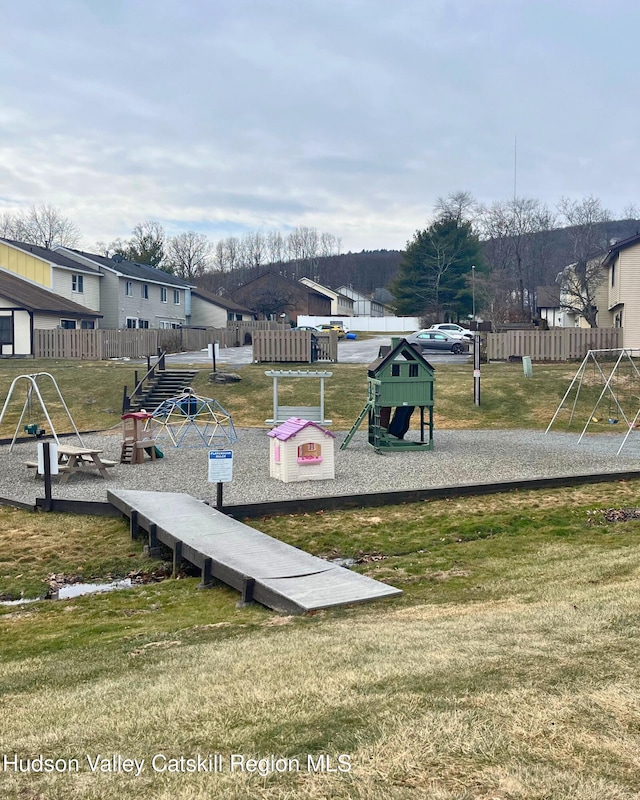 exterior space featuring a playground and a yard