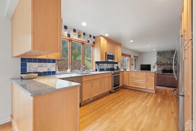57 Spencer Rd, Austerlitz, NY 12017 - kitchen featuring stainless steel appliances, a peninsula, a sink, light brown cabinets, and open floor plan