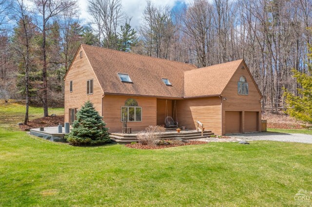 57 Spencer Rd, Austerlitz, NY 12017 - view of front of property with an attached garage, a front lawn, roof with shingles, and driveway