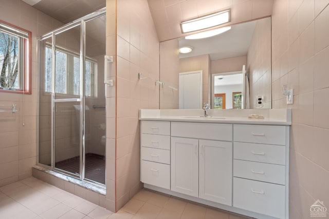 57 Spencer Rd, Austerlitz, NY 12017 - bathroom featuring tile walls, a shower stall, tile patterned floors, plenty of natural light, and vanity