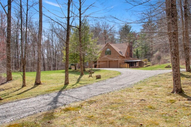 57 Spencer Rd, Austerlitz, NY 12017 - view of front of property featuring an attached garage, gravel driveway, a front yard, and a chimney
