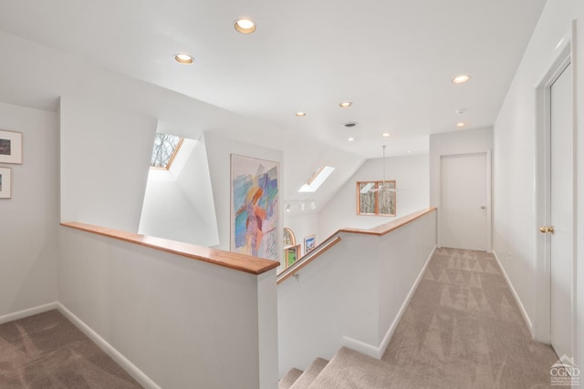 57 Spencer Rd, Austerlitz, NY 12017 - hall featuring carpet flooring, an upstairs landing, baseboards, a skylight, and recessed lighting