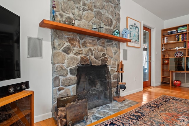 57 Spencer Rd, Austerlitz, NY 12017 - living area with wood finished floors, a fireplace, and baseboards