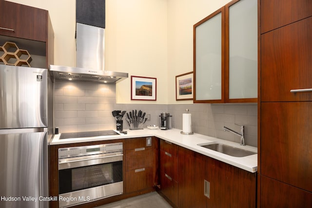 81 N Main St, Ellenville, NY 12428 - kitchen featuring light countertops, decorative backsplash, stainless steel appliances, wall chimney exhaust hood, and a sink