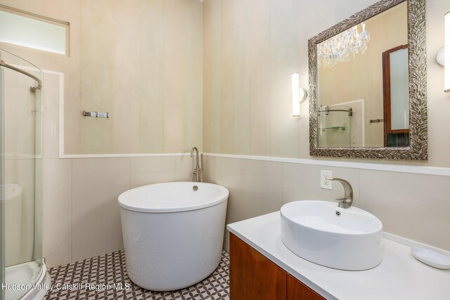 81 N Main St, Ellenville, NY 12428 - bathroom with vanity, a shower stall, and a freestanding bath