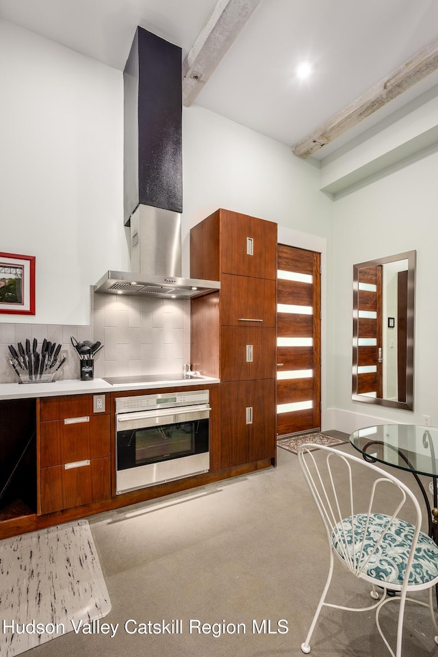 81 N Main St, Ellenville, NY 12428 - kitchen with stovetop, decorative backsplash, stainless steel oven, wall chimney exhaust hood, and modern cabinets