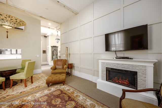 81 N Main St, Ellenville, NY 12428 - living room with a decorative wall, carpet flooring, a fireplace, and beamed ceiling
