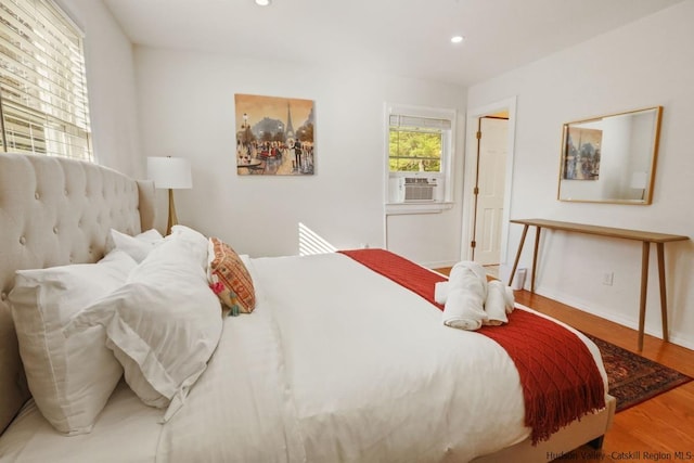 bedroom featuring hardwood / wood-style flooring and cooling unit