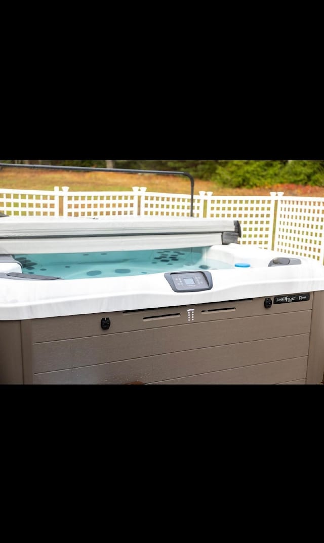 view of swimming pool featuring a hot tub