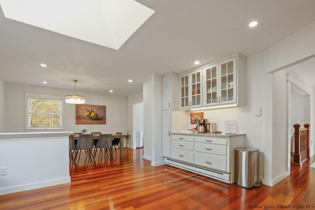 interior space with a chandelier, light hardwood / wood-style floors, and baseboard heating