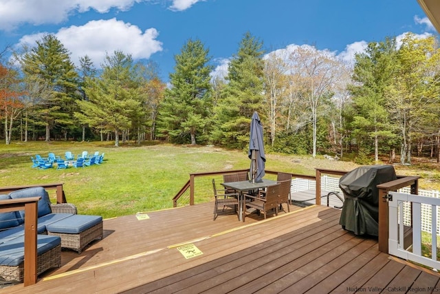 wooden deck featuring a lawn and area for grilling