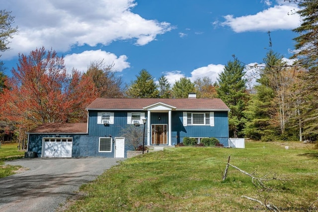 view of front of home featuring a garage and a front yard