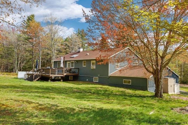 back of property featuring a yard and a deck