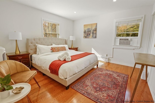 bedroom featuring light hardwood / wood-style flooring and cooling unit