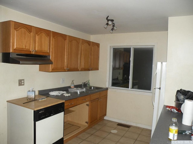 618 Bean River Rd, Pine Plains, NY 12567 - kitchen featuring under cabinet range hood, freestanding refrigerator, a sink, brown cabinetry, and light tile patterned floors