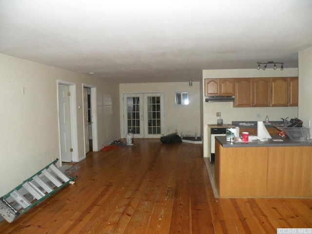 618 Bean River Rd, Pine Plains, NY 12567 - kitchen with brown cabinetry, wood finished floors, a peninsula, dark countertops, and french doors