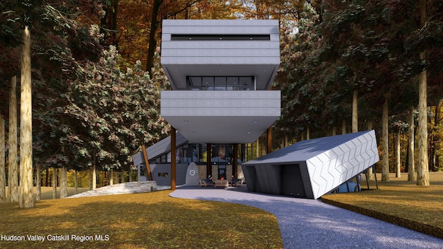 contemporary home featuring a front lawn and a carport