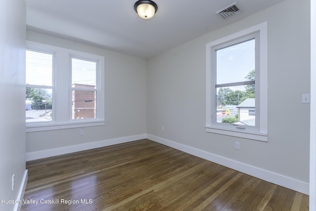 empty room featuring dark hardwood / wood-style flooring