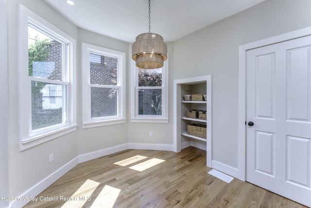 unfurnished dining area with light hardwood / wood-style floors