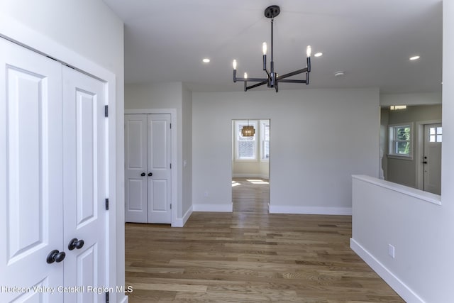 interior space featuring dark wood-type flooring and an inviting chandelier