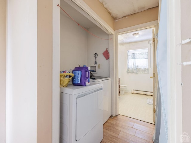 1769 Rte 51, Hannacroix, NY 12087 - washroom featuring independent washer and dryer, a baseboard heating unit, and light wood-type flooring