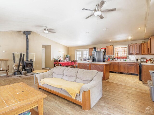 1769 Rte 51, Hannacroix, NY 12087 - living area featuring a ceiling fan, a wood stove, plenty of natural light, light wood-style floors, and lofted ceiling