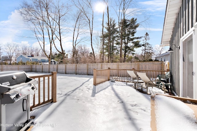 yard covered in snow with a fenced backyard