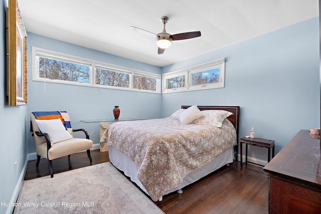 bedroom featuring dark wood-style floors, baseboards, and a ceiling fan