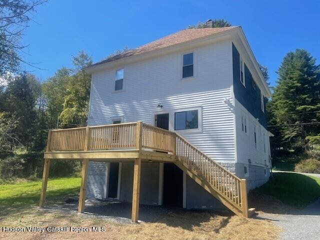 rear view of house featuring a deck