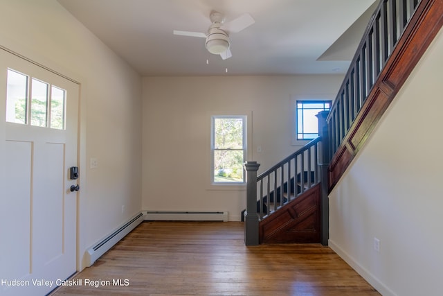 foyer with baseboard heating, ceiling fan, and hardwood / wood-style flooring