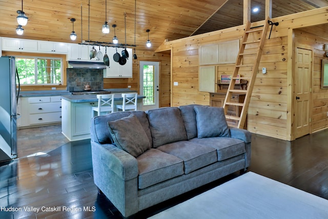 living room featuring wood ceiling, wooden walls, a healthy amount of sunlight, and vaulted ceiling