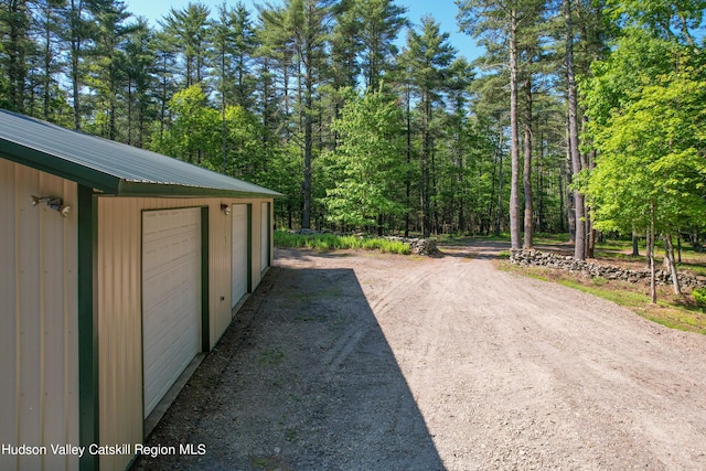 view of patio / terrace with an outbuilding and a garage