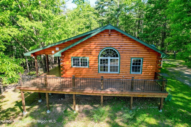 view of home's exterior with a wooden deck