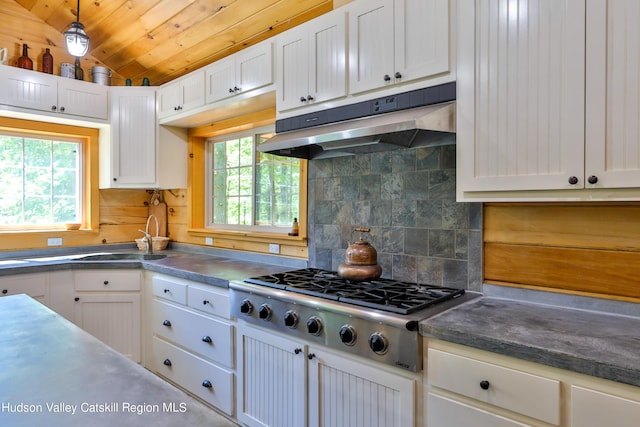 kitchen featuring stainless steel gas stovetop, white cabinetry, sink, and vaulted ceiling